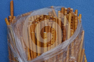 Food from dry brown straws in a torn gray plastic bag