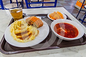 Food in an eatery in Almaty, Kazakhstan. Roulade with mashed potatoes, Borscht soup and carrot sala