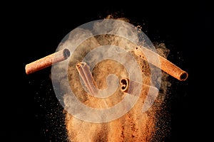 Food explosion with cinnamon sticks and powder photo