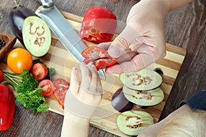 Food, family, cooking and people concept - Man giving paprika to the daughter