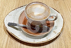 Hot cup of coffee cappuccino close up photo