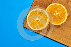 Food for fitness, healthy lifestyle, flat lay with fresh fat-burning fruits, slices of orange on the kitchen cutting board
