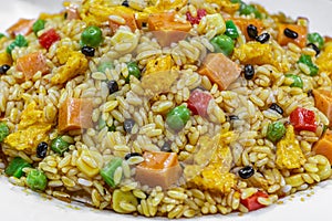 Food flat lay of traditional Chinese Fried Rice with vegetable and spices is on a big white plate photo