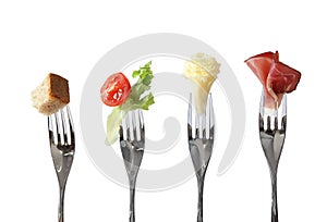 Food on forks: bread, vegetable, cheese and meat