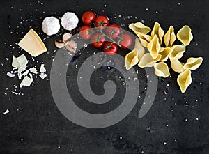 Food frame. Pasta ingredients on dark grunge backdrop, copy space