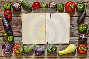 Food frame with vitage cookbook on wooden background.