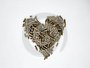 Food green pellets for a hamster, rabbit, guinea pig, mouse, chinchilla, degu.Food pellets for a rodent isolated on a white