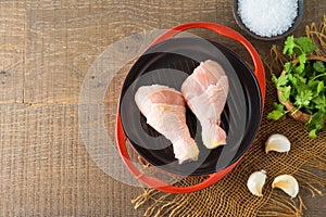 Food and healthy eating concept. Fresh raw chicken legs on wooden table