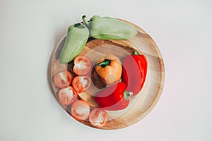 Food, healthy eating and nutrition concept - sliced pumpkin and other vegetables on wooden board