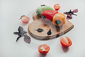 Food, healthy eating and nutrition concept - sliced pumpkin and other vegetables on wooden board