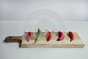 Food, healthy eating and nutrition concept - sliced pumpkin and other vegetables on wooden board