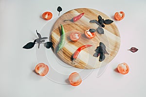 Food, healthy eating and nutrition concept - sliced pumpkin and other vegetables on wooden board