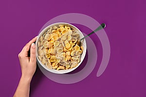 Food, healthy eating, people and diet concept - close up of woman eating muesli for breakfast over purple background