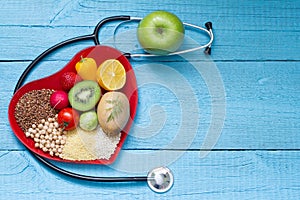 Food on heart plate with stethoscope cardiology concept