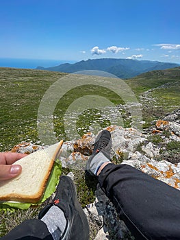 food on a hike a man with bread sitting on a mountain journey