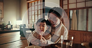 Food, home and Japanese mother and child at table for lunch, breakfast and eating meal together. Happy family, culture