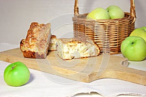 Food. Homemade apple pie. Charlotte and wicker basket with apples. Rustic background horizontal. Selective focus