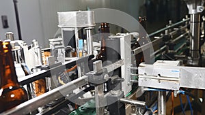 Food industry. Automatic Beer Bottling Line. Applying the label. Machine for pasting labels for beer bottles. 4k