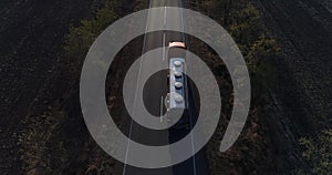 food industry, drone flying over truck for production of milk is leaving the farm and driving along road