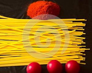 Food ingredients for italian pasta, spaghetti on black stone slate background.