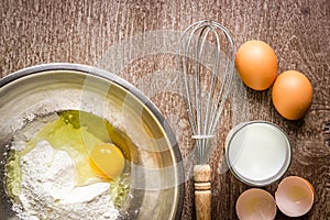 Food ingredients and kitchen utensils for cooking on wooden background