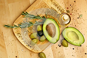 Food Ingredients. Olive Oil With Olives And Avocado On Table