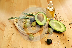 Food Ingredients. Olive Oil With Olives And Avocado On Table