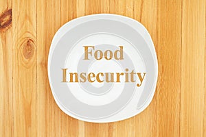 Food Insecurity message on white empty plate photo