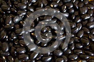 Food item - black beans grains with a warm and yellow background