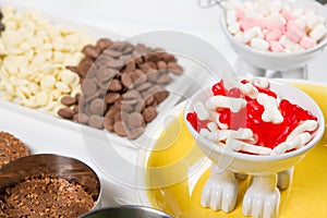 Food, junk-food, culinary, baking and eating concept - close up of jelly beans candies and chocolate on table