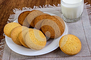 Food, junk-food, culinary, baking and eating concept - close up oatmeal cookies and milk glass