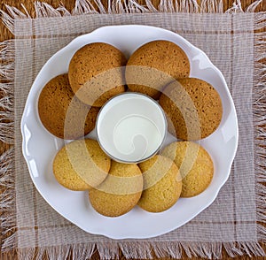 Food, junk-food, culinary, baking and eating concept - close up oatmeal cookies and milk glass