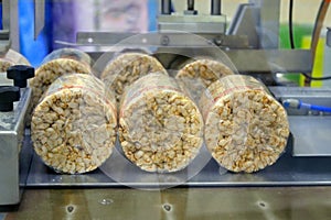 Food manufacture - Stack of puffed whole grain crispbread. packing organic multi barley briquetted crispbread on factory