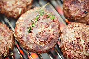 Food meat - beef burgers on bbq barbecue grill with flame