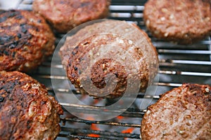 Food meat - beef burgers on bbq barbecue grill with flame