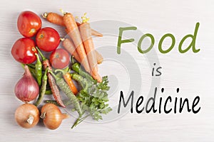 Food is Medicine text with assorted vegetables