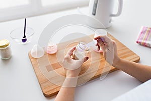 Hands with infant formula making baby milk