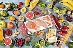 Food, overhead photo of many different products, with meat, fish, chicken and shrimps, vegetables and fruits, legumes, wine, pasta