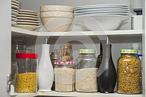 Food pantry with storage jars of pasta rice jasmine