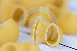 Food.Pasta raw closeup background. Delicious dry uncooked ingredient for traditional Italian cuisine dish. Textured