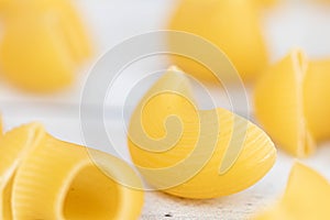 Food.Pasta raw closeup background. Delicious dry uncooked ingredient for traditional Italian cuisine dish. Textured