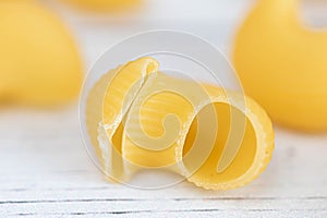 Food.Pasta raw closeup background. Delicious dry uncooked ingredient for traditional Italian cuisine dish. Textured