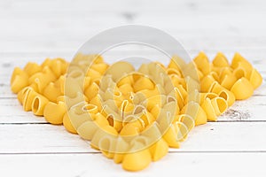 Food.Pasta raw closeup background. Delicious dry uncooked ingredient for traditional Italian cuisine dish. Textured