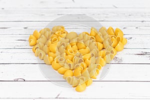 Food.Pasta raw closeup background. Delicious dry uncooked ingredient for traditional Italian cuisine dish. Textured