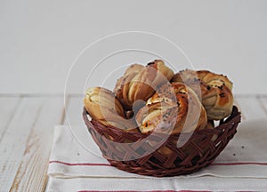Food pastry background.Homemade buns in a natural basket on a white wooden background