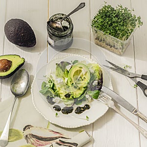 Food photo mix lettuce with avocado, feta cheese and mint sauce