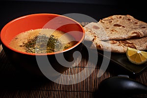 Food photo, Turkish lentil soup in a bowl with two slices of chapati bread, Oriental Turkish menu meal vegan dish, vegetarian food