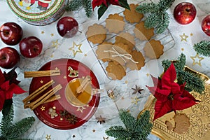 Food photography of a Christmas table decorated with gingersnap cookies, cinnamon and pine