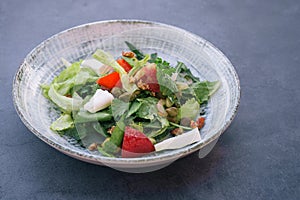 Food photography of a fresh vegetables and feta salad. Mediterranean diet. Fresh vegetarian dish