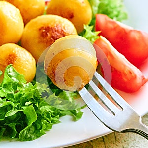 Food on a plate. potatoes, tomatoes, lettuce